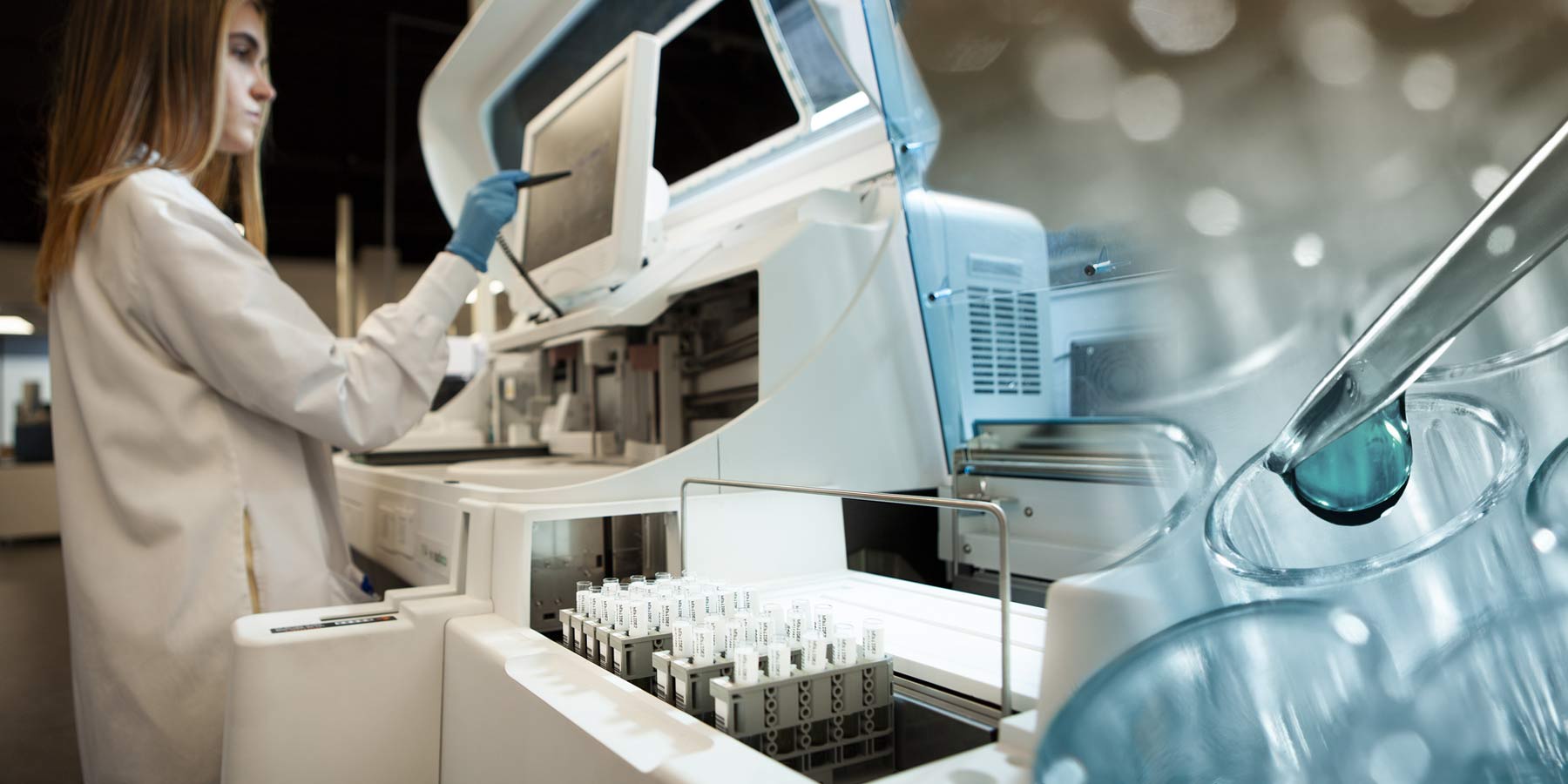 A female scientist operating an automated clinical analyzer alongside a close-up of a pipette dispensing liquid into a laboratory vial.